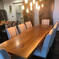 a large wooden table with white chairs around it