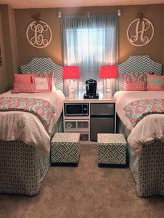 two twin beds in a bedroom with pink and blue bedding