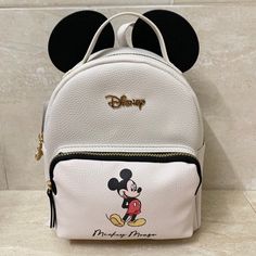 Brand New With Tags!! Disney Mickey Mouse With Ears Backpack Adjustable Shoulder Straps Top Handle Disney Mickey Head Shaped Zipper Pull Interior Zipper Pocket Zip Top Front Zippered Pocket 10”H X 8.5”L X 4”D Primark Exclusive! White Backpack For Disney Trips, White Disney Travel Backpack, Disney White Bags For Disney Trips, Cute Mickey Mouse Bags For Travel, Disney Leather Backpack For School, White Disney Backpack For School, Disney Leather School Backpack, Disney White Backpack For School, Disney Minnie Mouse White Bag