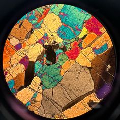 thin section of geologic sample seen through microscope lens