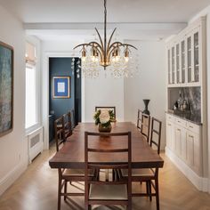 a dining room table with chairs and a chandelier