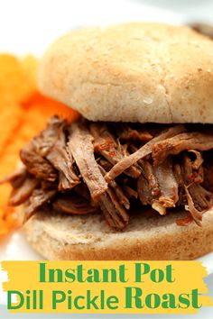 a close up of a sandwich on a plate with carrots and potatoes in the background