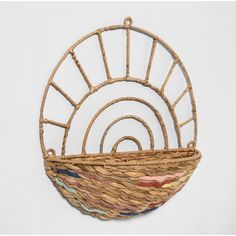 a woven basket hanging on the wall