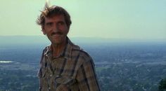 a man standing on top of a tall building