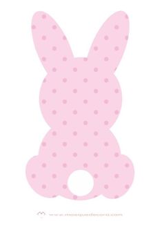 a pink bunny shaped cutout with polka dots