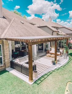 a covered patio with furniture and an outdoor living area in the back yard on a sunny day