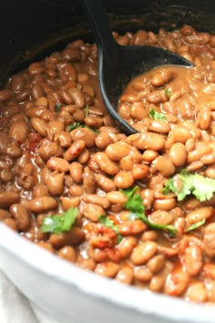 a pot filled with beans and garnished with cilantro