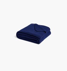 a folded blue towel on a white background