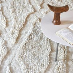 a table with a book on it and a wooden object sitting on top of it