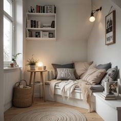 a small room with a window seat and some books on the shelf next to it