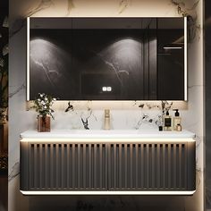 a bathroom with marble counter tops and black cabinetry, along with two vases filled with flowers