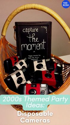 a basket filled with cameras next to a sign that says, capture the moment 2009 themed party ideas disposable cameras