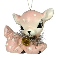 an ornament shaped like a baby deer with a bell on its neck and nose