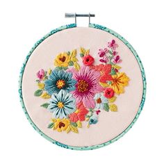 an embroidery kit with colorful flowers on the front and back of it's hoop