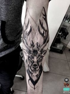 a man with a deer tattoo on his arm