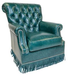 a green leather chair with tassels on the arms and foot rests against a white background