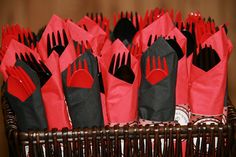 red and black napkins with forks on them in a wicker basket, ready to be eaten