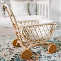 a baby's crib in the middle of a rug with pillows on it