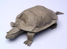 an origami tortoise on a white background