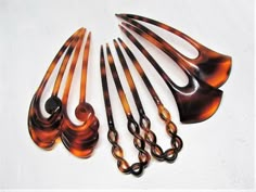 "The perfect hair forks for adding a special touch to chignons, buns and other updos. A set of 2 classic vintage 1970's hair pins from France, in your choice of three Art Deco designs. They are made of high-quality Lucite plastic in a marbled brown tortoiseshell pattern. They are quite sturdy and measure 4\" long. The hair sticks are new old stock (NOS) meaning they are unused vintage store stock, so there are multiple quantities of each style available. I was so happy to have found these pins! Antique Hair Pins, 1970's Hair, 1970s Hair, French Pin, 1970s Hairstyles, Black Hair Accessories, Bun Pins, Chignon Bun, Hair Forks