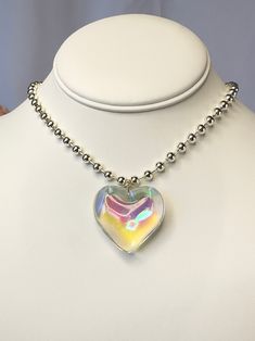 Make a statement with this gorgeous glass heart necklace! Featuring a stunning iridescent glass heart pendant on a stainless steel ball chain. Choose between 15 or 16 inch length. Clear Heart Necklace, Iridescent Heart Pendant Jewelry For Valentine's Day, Heart-shaped Glass Necklaces For Jewelry Making, Heart Shaped Glass Necklace, Heart-shaped Glass Necklace, Number Jewelry, Number Necklace, Friendship Jewelry, Healing Crystal Jewelry