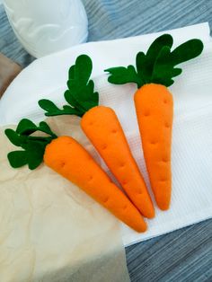 three carrots are sitting on a napkin