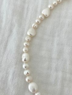 The loveliest pearl necklace! Composed of real, freshwater pearls ranging from 5-9mm and finished off with all gold filled materials. Nickel and lead free. Adjustable 15-17in. Everyday Baroque Pearl Necklace In Pearl White, Everyday Baroque Pearl White Necklace, Everyday Single Strand Pearl Necklace, Everyday Single Strand Pearl Necklace With Round Beads, Everyday Single Strand Baroque Pearl Necklace, Everyday Pearl Necklace With Pearl Charm, Adjustable Everyday Pearl Necklace, Classic Everyday Baroque Pearl Necklace, White Pearl Necklace For Everyday