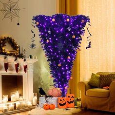 a living room decorated for halloween with purple lights and pumpkins on the fireplace mantel