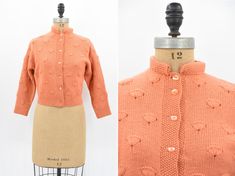 "Vintage 1950s wool knit. Vibrant creamsicle orange. Fan design throughout. Long sleeves and high 1 1/2\" collar. Front button closure. Unlined.  State of garment | excellent  Measurements ✂--- Best fit |  Large *has give Bust | up to 38-40 \" Shoulders | not specified / apron 15\" Shoulder to waist | not specified  Sleeves | aprox 19 \" Waist | 30.5- 32\" Total length (shoulder to hem) | 19 1/4\" Tag | none present  ★★Visit The Shop★★ http://www.etsy.com/shop/seaofvintage ➸ Find the shop on Ins Retro Fitted Sweater With Button Closure, Vintage Orange Sweater For Fall, Retro Orange Cardigan For Winter, Retro Orange Winter Cardigan, Vintage Wool Sweater For Spring, Retro Fitted Wool Sweater, Fitted Wool Vintage Cardigan, Vintage Fitted Sweater With Buttons, Fitted Vintage Sweater With Buttons