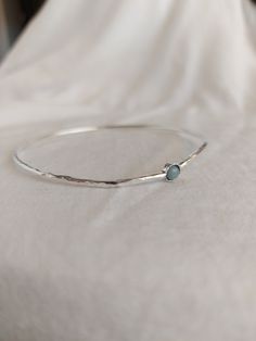 "The Sterling silver bangle bracelet is perfect in its simplicity. Hammered bangle for women. For a modern and trendy look. 4mm. natural Aquamarine stone set in a decorated stone house. Choose your length look at the picture to know how to take the right size. for other lengths please convo me. Very important! to avoid mistakes, please make sure you have the right size. If you not sure then look at item photos and learn how to do it. x-small - 2.25\" diameter 7.5\"circumference small - 2.5\" dia Silver Slim Band Bracelet For Gift, Stackable Sterling Silver Bangle Bracelet As Gift, Sterling Silver Bangle Bracelet For Gift, Sterling Silver Stackable Bangle Bracelet Gift, Minimalist Birthstone Bangle Jewelry, Simple Bangle Bracelets As Gifts, Silver Birthstone Bangle Jewelry, Simple Bangle Bracelet As Gift, Simple Design Bangle Bracelet For Gift