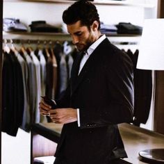 a man in a suit looking at his cell phone