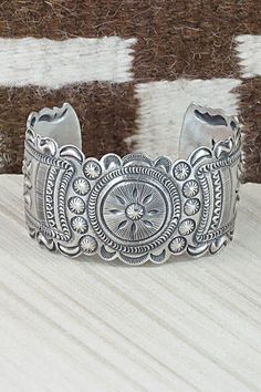 "This sterling silver bracelet was made by Navajo silversmith Eugene Charley. The inside is signed and stamped sterling. Size: 5 3/4\" (will fit up to a 7\" wrist) Gap: 1 1/4\" Width: 1 1/2\" Free shipping on all orders! We ship with USPS and always include tracking. All orders ship within a day of payment. Returns are accepted up to 30 days after you receive your order. Just send us a message. Our shop offers cash back or store credit. The item must be returned in new condition." Artisan Sterling Silver Bracelet With Intricate Design, Artisan Sterling Silver Bracelets With Intricate Design, Artisan Silver Bracelet With Stamped Details, Artisan Sterling Silver Bracelet With Polished Finish, Sterling Silver Stamped Bracelet, Navajo Bracelet, Sterling Silver Bracelet, Native American Jewelry, Bracelets And Charms