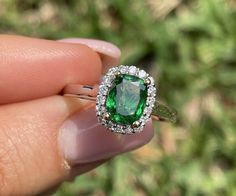 Up for sale this stunning color natural Green Tsavorite Garnet and natural earth mined Diamond. One-of-a-Kind Designer May Design Ring  CENTER STONE:  Genuine Natural IGI Certified Chrome Green Tsavorite Garnet 1.32 ct.  COLOR: Green Chrome and Emerald like green. Very pretty color  SHAPE: Pear .  CLARITY: Stone has some inclusions, they do not impact stone color intensity. Stunning color and lovely sparkle! DIAMOND WEIGHT:  0.33 ct SHAPE/ CUT: Round Brilliant Cut  CLARITY: VS2-SI2  COLOR: GH. Tsavorite Ring, Chrome Green, Tsavorite Garnet, Garnet Jewelry, Detailed Ring, Green Diamond, Diamond Halo, Sparkle Diamonds, Cocktail Ring