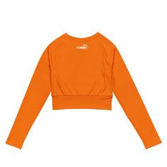 Fall in love with this versatile piece of eye-catching activewear. Our eco-friendly always bright orange cropped rash guard –made with recycled polyester and elastane– is the perfect choice for swimming, sports, or athleisure outfits. The long sleeves and cropped cut provides just enough coverage while the UPF 50+ rated material helps block the sun’s harsh UV rays. Stand out in confidence and comfort all year long in our “wear anywhere” cropped top. .: Made with 81% REPREVE recycled polyester, 1 Fitted Orange Gym Tops, Fitted Orange Top For Gym, Orange Stretch Tops For Yoga, Orange Stretch Yoga Tops, Stretch Orange Yoga Tops, Orange Yoga Tops, Stretch Orange Cropped Top, Orange Stretch Sports Tops, Stretch Orange Tops For Sports