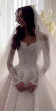 a woman wearing a wedding dress and veil