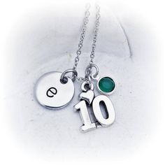 a necklace with the number ten and two charms