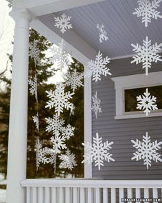 snowflakes hanging from the side of a house