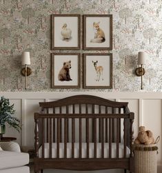 a baby's room with pictures on the wall and a crib next to it