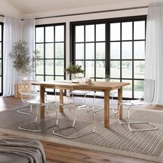 a living room with large windows and a wooden table