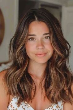 Smiling woman with wavy brown hair and a gentle expression. Coppery Brown Hair Caramel Highlights, Light Auburn Highlights In Brown Hair, Caramel Highlights In Brown Hair, Warm Brown With Blonde Highlights, Brown Hair With Highlights And Layers, Honey Caramel Highlights On Brown Hair, Caramel Highlights On Light Brown Hair, Brown Hair Balyage