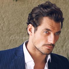 a close up of a person wearing a suit and tie with a serious look on his face