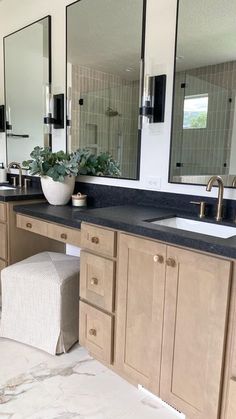 a bathroom with two sinks and mirrors in it