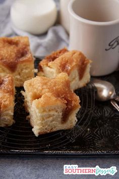 several pieces of cake sitting on a plate next to a cup