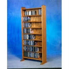 a wooden bookcase with several dvd's on top and two dvds in the bottom