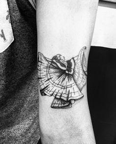 a black and white photo of a woman's arm with a tattoo on it