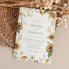 a wedding card with sunflowers on it next to a basket and wicker