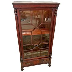 an old wooden cabinet with glass doors