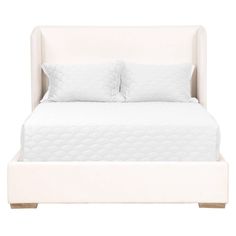 a white bed with two pillows on it