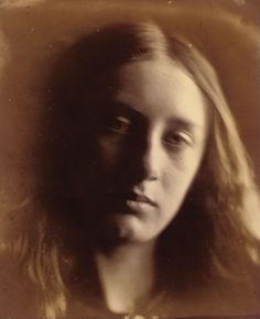 an old photo of a woman with long hair