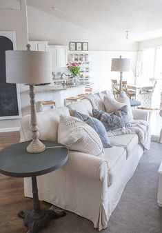 a living room filled with furniture and a lamp